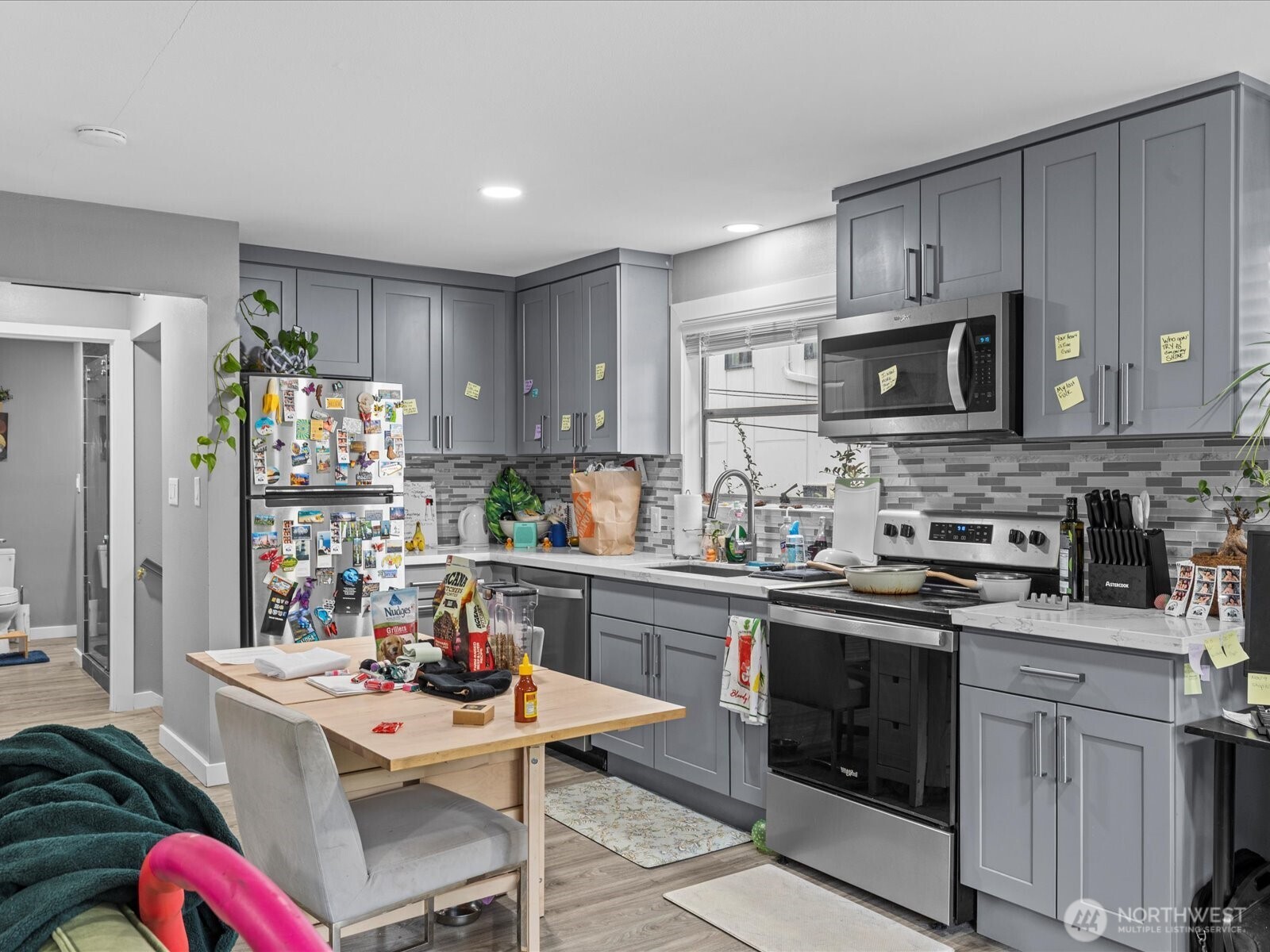 7138 47th Avenue Southwest Seattle, WA 98136 - Photo 6 of 20 a kitchen with stainless steel appliances granite countertop a stove refrigerator sink and cabinets