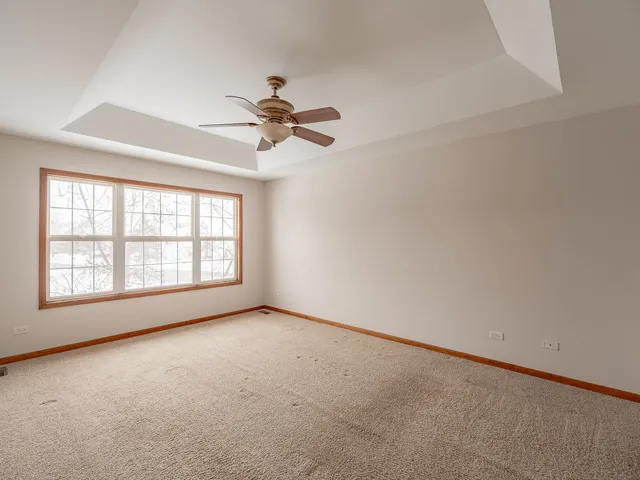 an empty room with a empty space and a ceiling fan