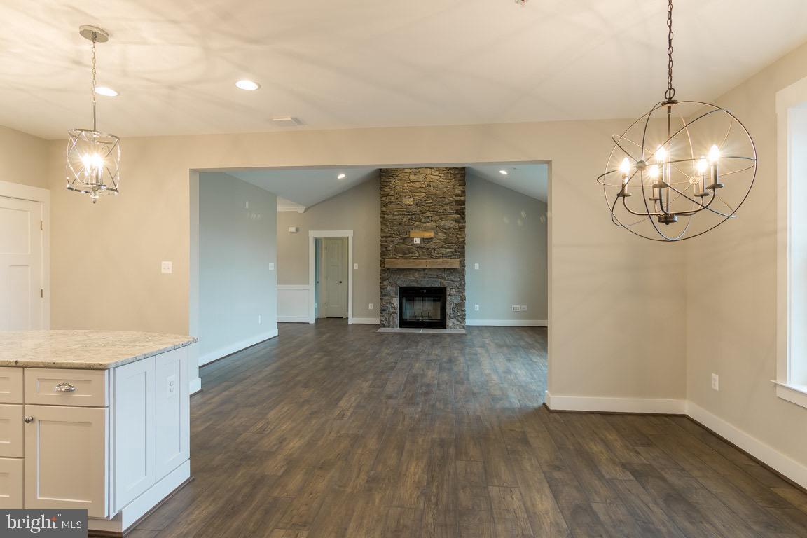 3100 Thurston Road Frederick, MD 21704 - Photo 14 of 35 a view of a livingroom with a chandelier fireplace and wooden floor