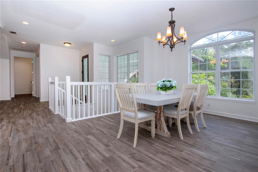 1422 Lightfoot Road Wimauma, FL 33598 - Photo 17 of 98 a view of a dining room with furniture wooden floor and chandelier