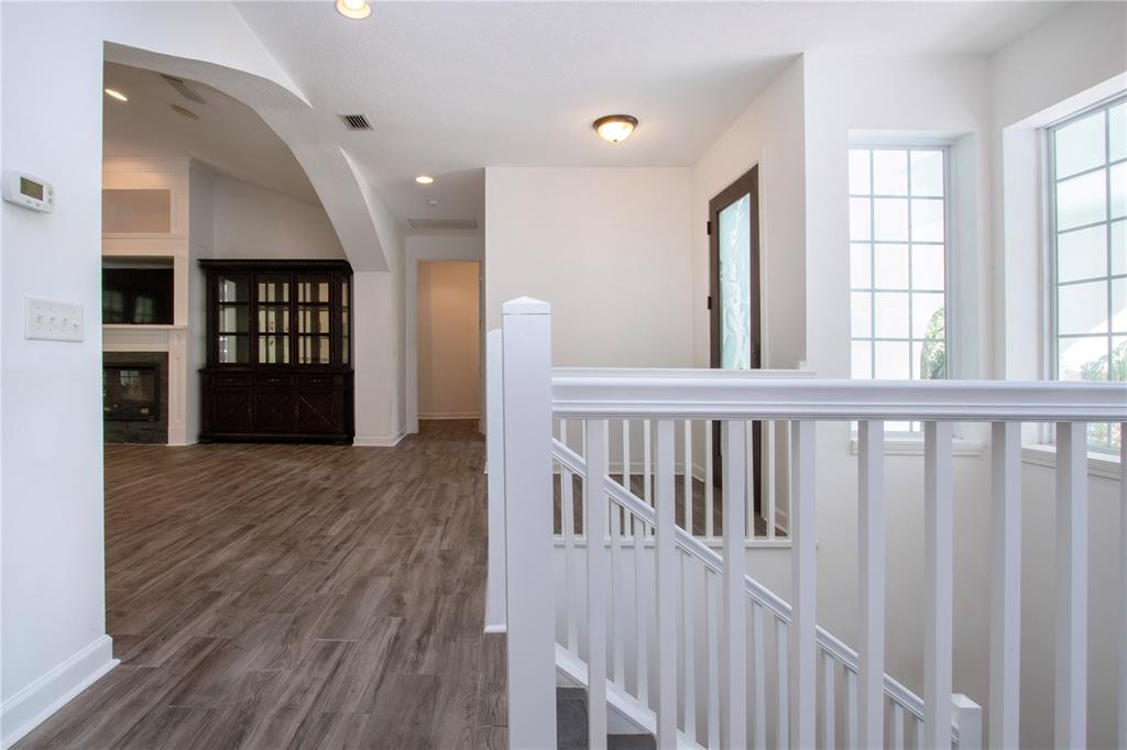 1422 Lightfoot Road Wimauma, FL 33598 - Photo 18 of 98 a view of a hallway with wooden floor and windows