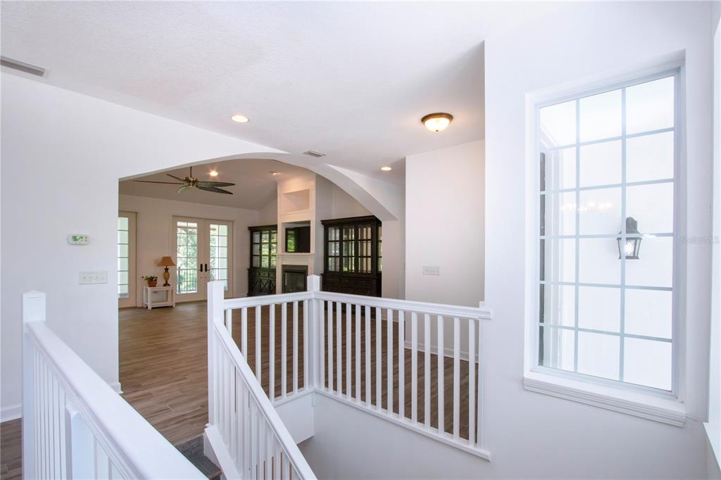 1422 Lightfoot Road Wimauma, FL 33598 - Photo 19 of 98 a view of a hallway with wooden floor and entryway