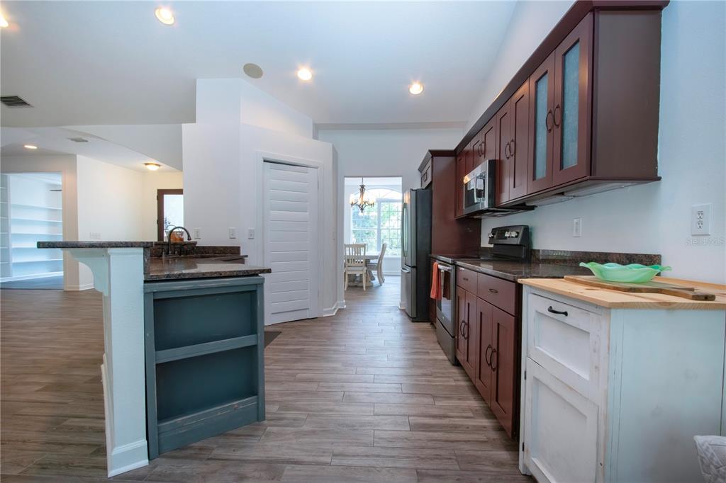 1422 Lightfoot Road Wimauma, FL 33598 - Photo 29 of 98 a kitchen with stainless steel appliances granite countertop a stove and a refrigerator