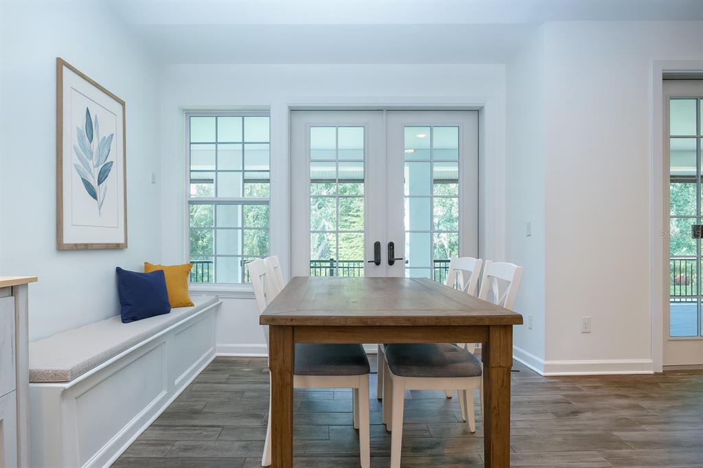 1422 Lightfoot Road Wimauma, FL 33598 - Photo 33 of 98 a view of a dining room with furniture and wooden floor