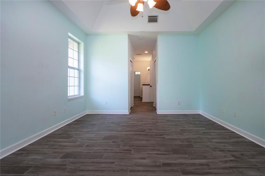 1422 Lightfoot Road Wimauma, FL 33598 - Photo 36 of 98 wooden floor in an empty room with a window