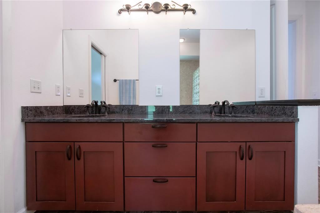 1422 Lightfoot Road Wimauma, FL 33598 - Photo 37 of 98 a bathroom with a granite countertop sink and a mirror