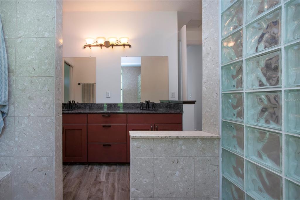 1422 Lightfoot Road Wimauma, FL 33598 - Photo 40 of 98 a bathroom with a double vanity and a mirror