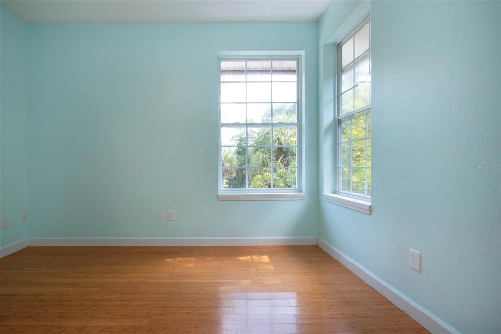 1422 Lightfoot Road Wimauma, FL 33598 - Photo 43 of 98 an empty room with wooden floor and windows