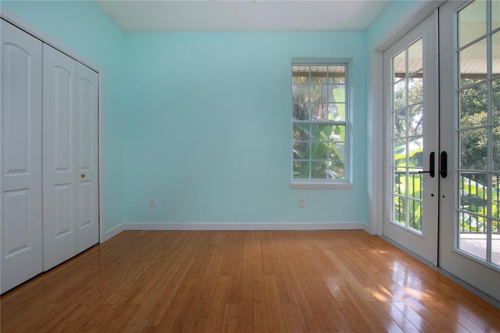 1422 Lightfoot Road Wimauma, FL 33598 - Photo 47 of 98 an empty room with wooden floor and windows