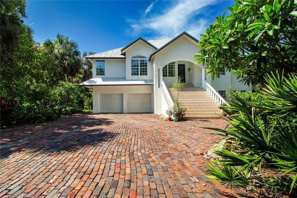 1422 Lightfoot Road Wimauma, FL 33598 - Photo 5 of 98 a front view of a house with a yard and trees