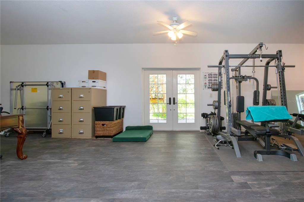 1422 Lightfoot Road Wimauma, FL 33598 - Photo 65 of 98 a view of a livingroom with furniture and a workspace