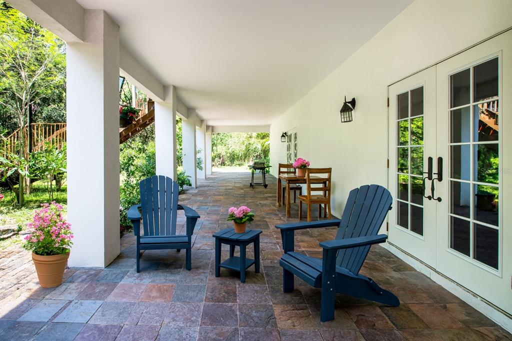 1422 Lightfoot Road Wimauma, FL 33598 - Photo 70 of 98 a view of a porch with furniture and potted plants