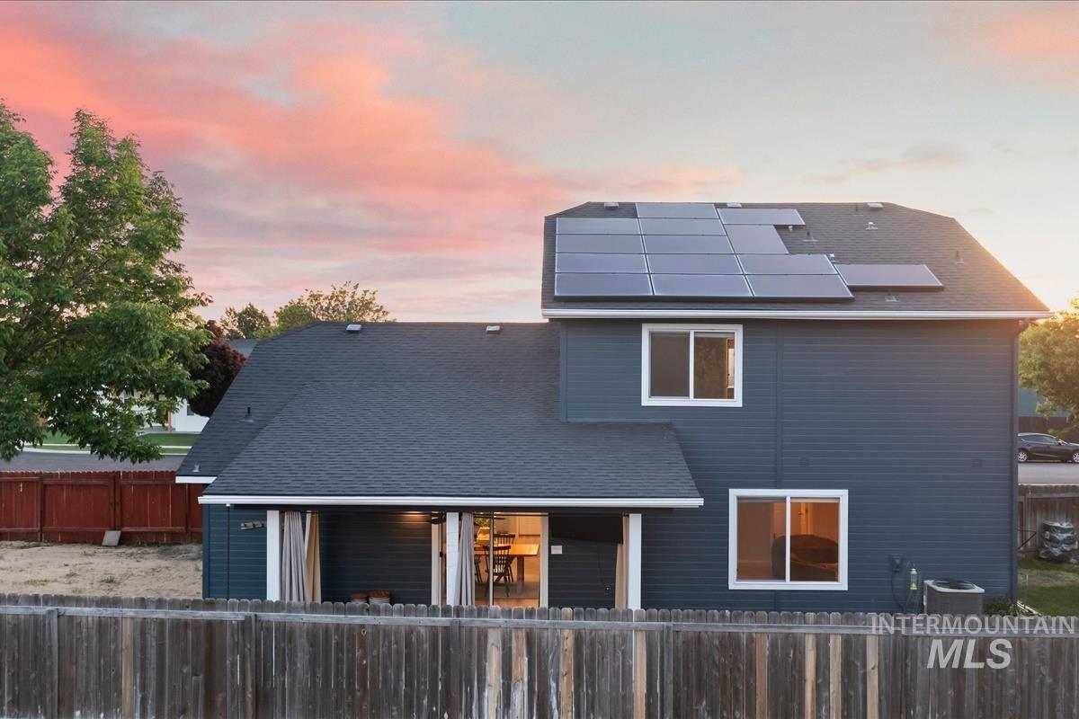 80 Cobblestone Court Middleton, ID 83644 - Photo 41 of 48 Rear exterior featuring a dark gray siding, a dark asphalt shingle roof, and multiple solar panels