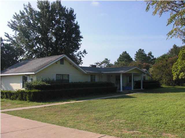 5686 Old Bethel Road Crestview, FL 32536 - Photo 2 of 5 a front view of a house with a garden