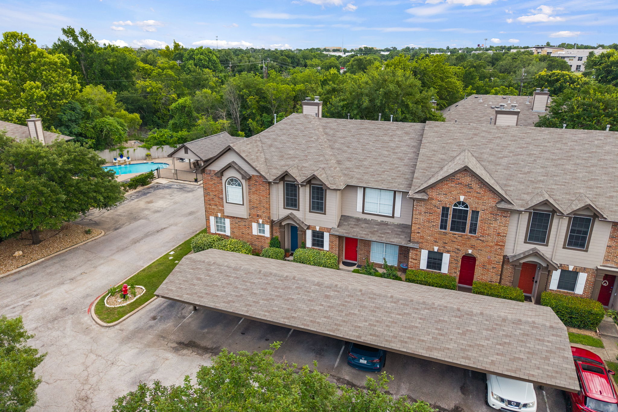 12401 Los Indios Trail, Unit 32 Austin, TX 78729 - Photo 35 of 39 Experience lock and leave convenience, featuring covered parking and a refreshing community pool.