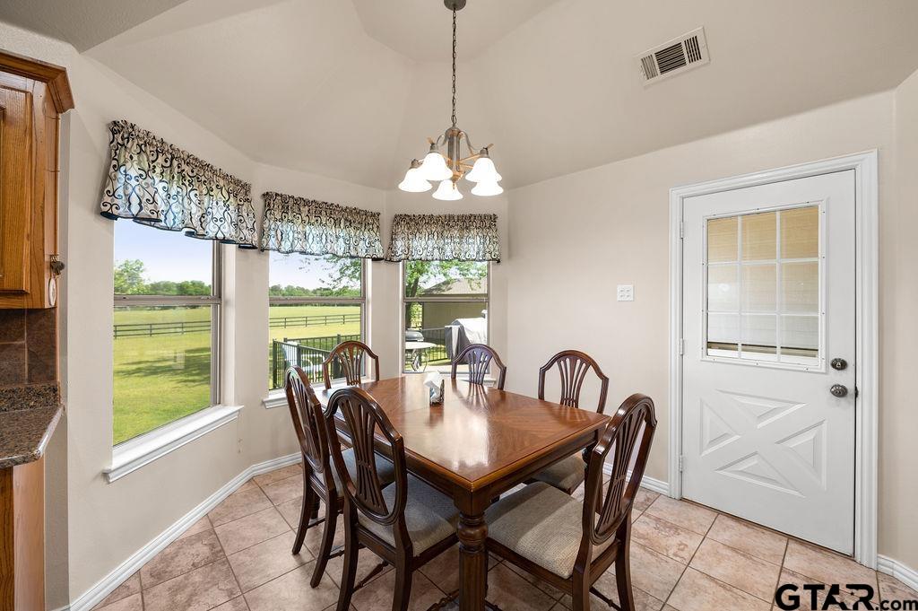 863 County Road 2950 Alba, TX 75410 - Photo 11 of 33 a dining room with furniture a chandelier and window