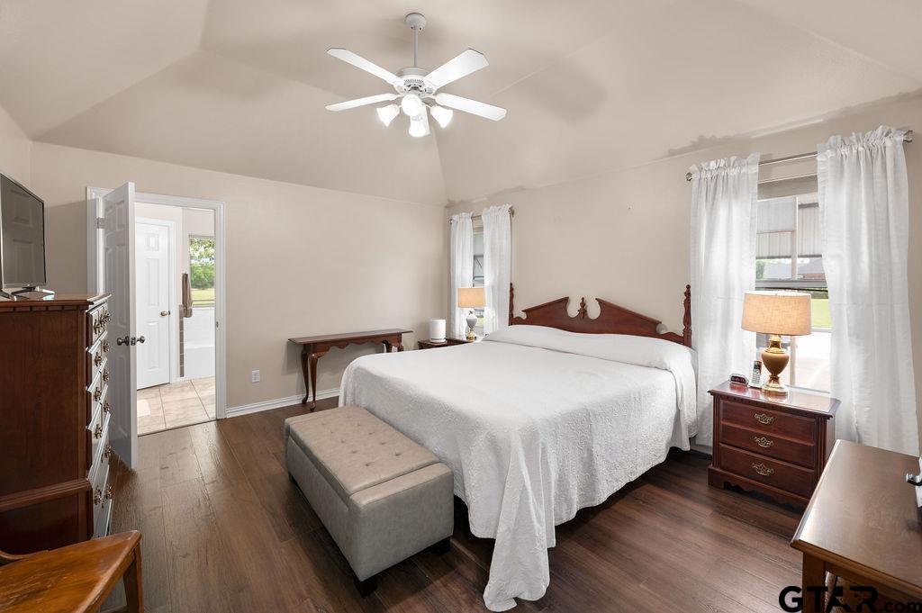 863 County Road 2950 Alba, TX 75410 - Photo 12 of 33 a bedroom with a bed and a chandelier