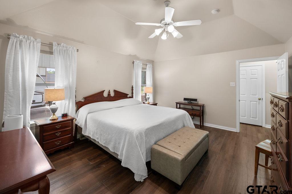 863 County Road 2950 Alba, TX 75410 - Photo 13 of 33 a bedroom with a large bed a chandelier and dresser