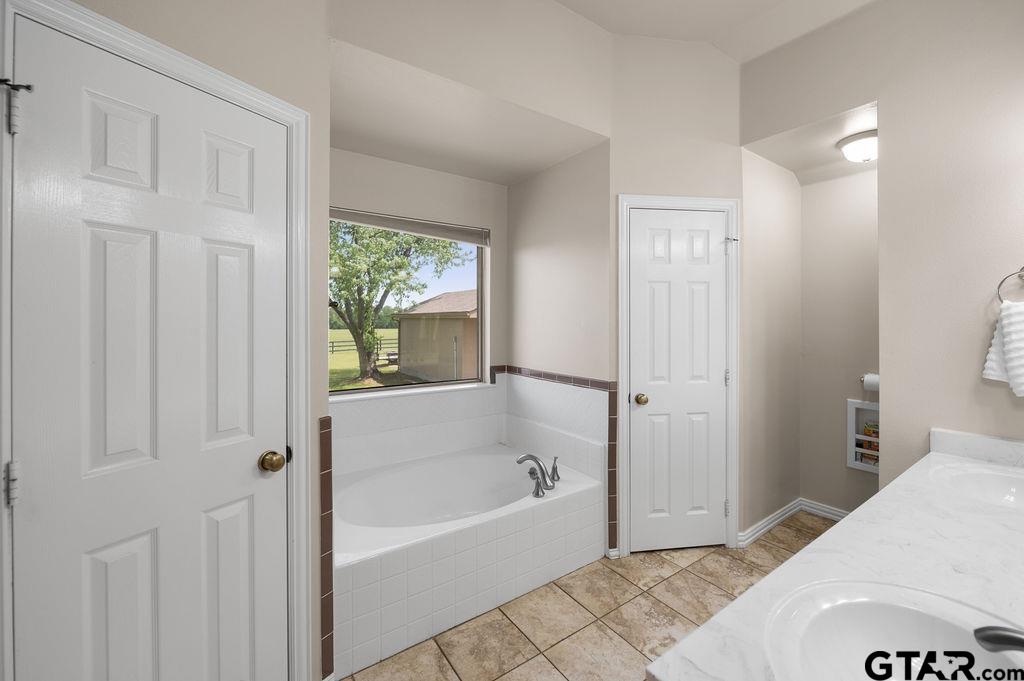 863 County Road 2950 Alba, TX 75410 - Photo 14 of 33 a bathroom with a bathtub and shower