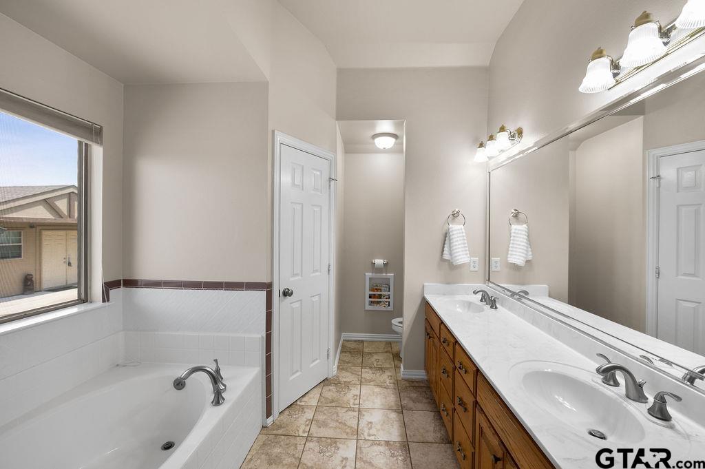 863 County Road 2950 Alba, TX 75410 - Photo 15 of 33 a spacious bathroom with a tub sink shower and mirror