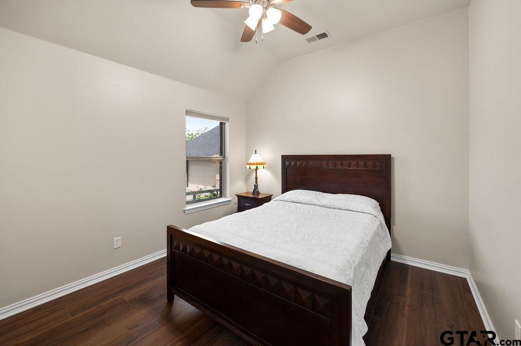 863 County Road 2950 Alba, TX 75410 - Photo 17 of 33 a bed room with a bed and a night stand