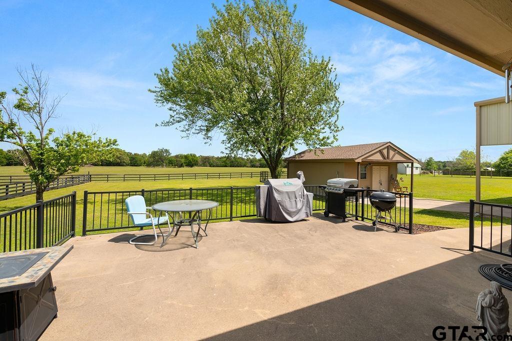 863 County Road 2950 Alba, TX 75410 - Photo 21 of 33 a view of a lake with a table and chairs under an umbrella