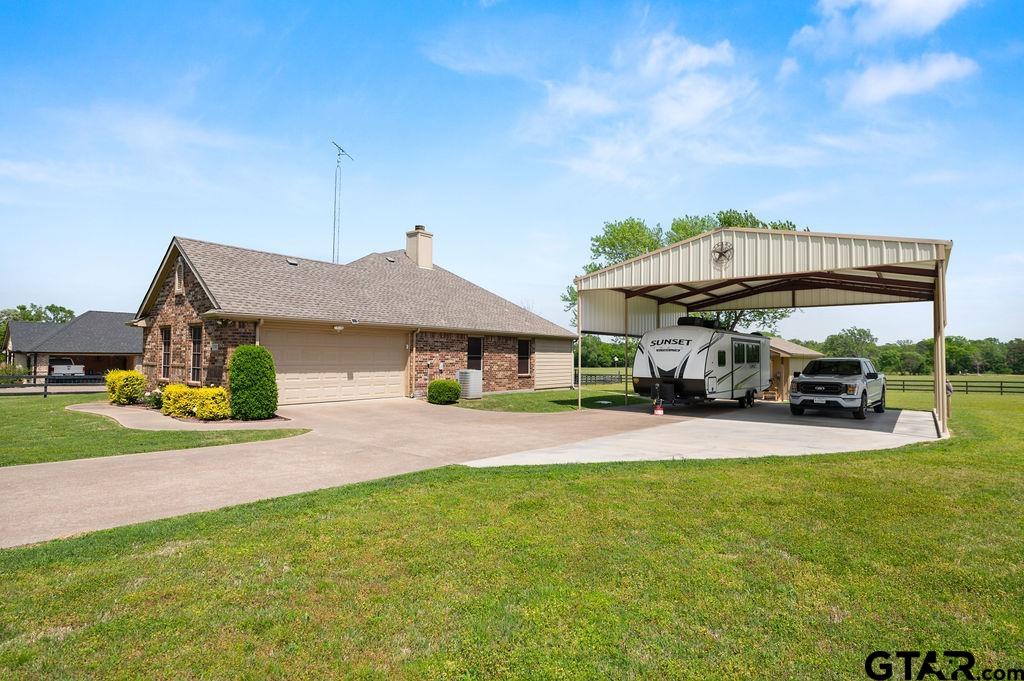 863 County Road 2950 Alba, TX 75410 - Photo 5 of 33 a front view of a house with garden