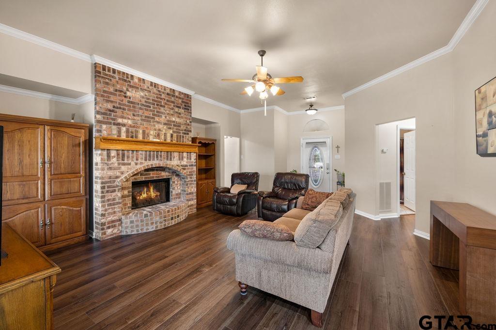 863 County Road 2950 Alba, TX 75410 - Photo 8 of 33 a living room with furniture a fireplace and a chandelier