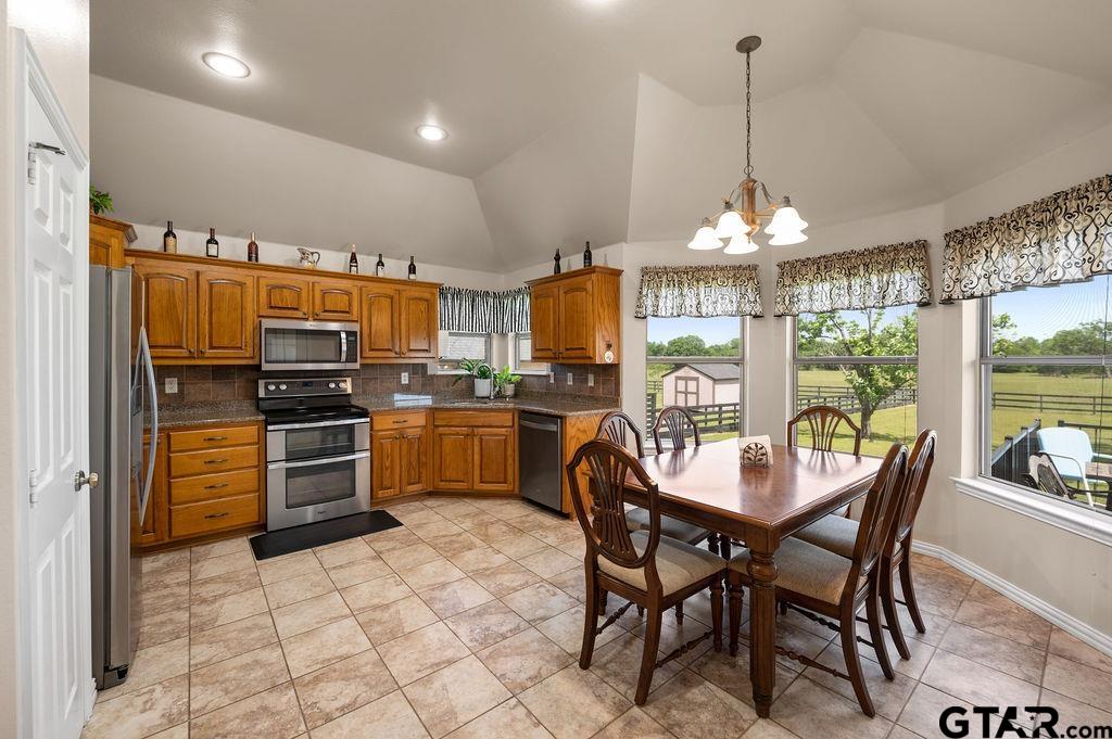 863 County Road 2950 Alba, TX 75410 - Photo 9 of 33 a kitchen with stainless steel appliances a table chairs and refrigerator