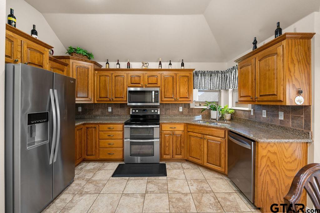 863 County Road 2950 Alba, TX 75410 - Photo 10 of 33 a kitchen with stainless steel appliances granite countertop a refrigerator stove top oven a sink and dishwasher
