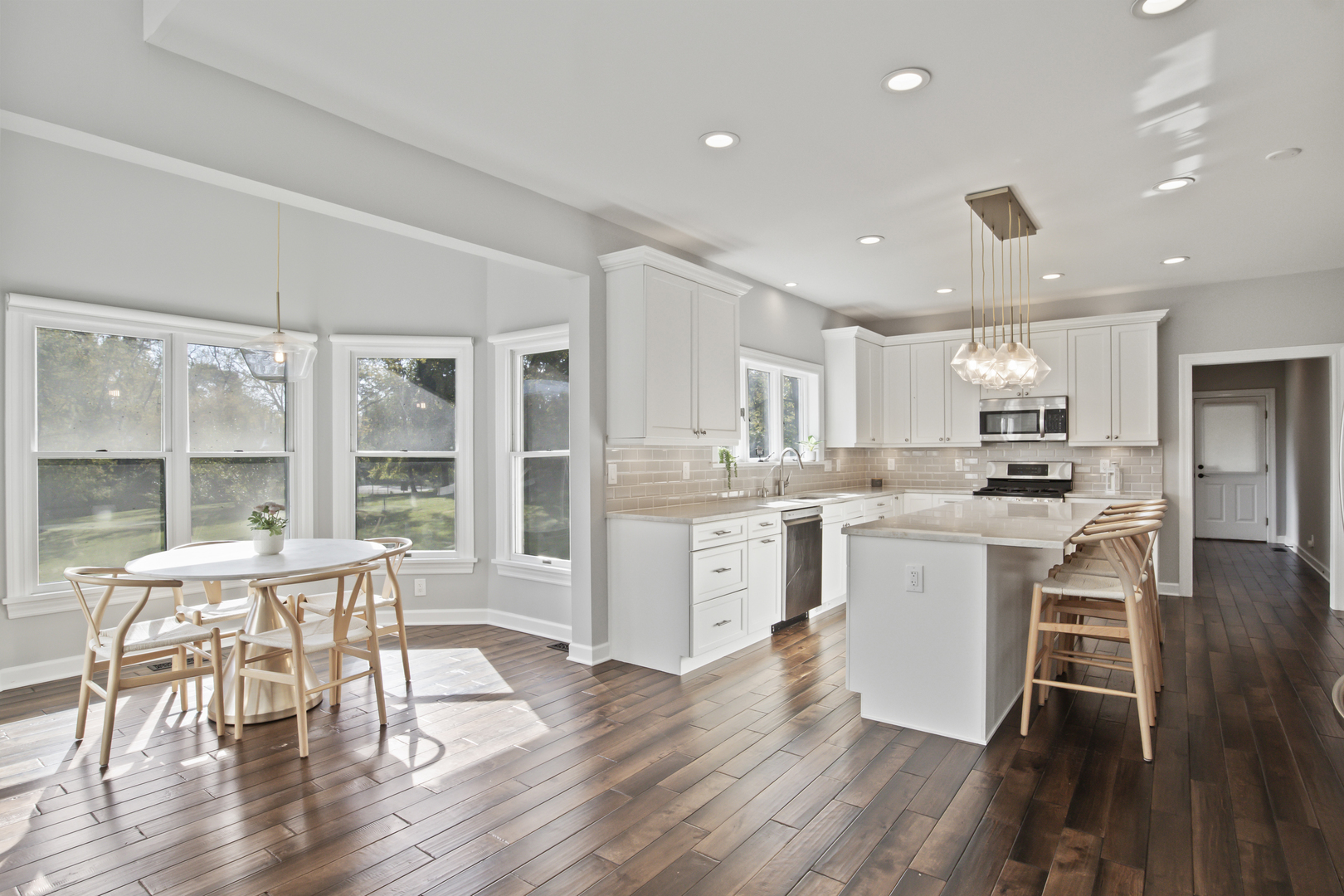 36W669 Crane Road St. Charles, IL 60174 - Photo 14 of 62 a kitchen with a table chairs wooden floor and a view of kitchen