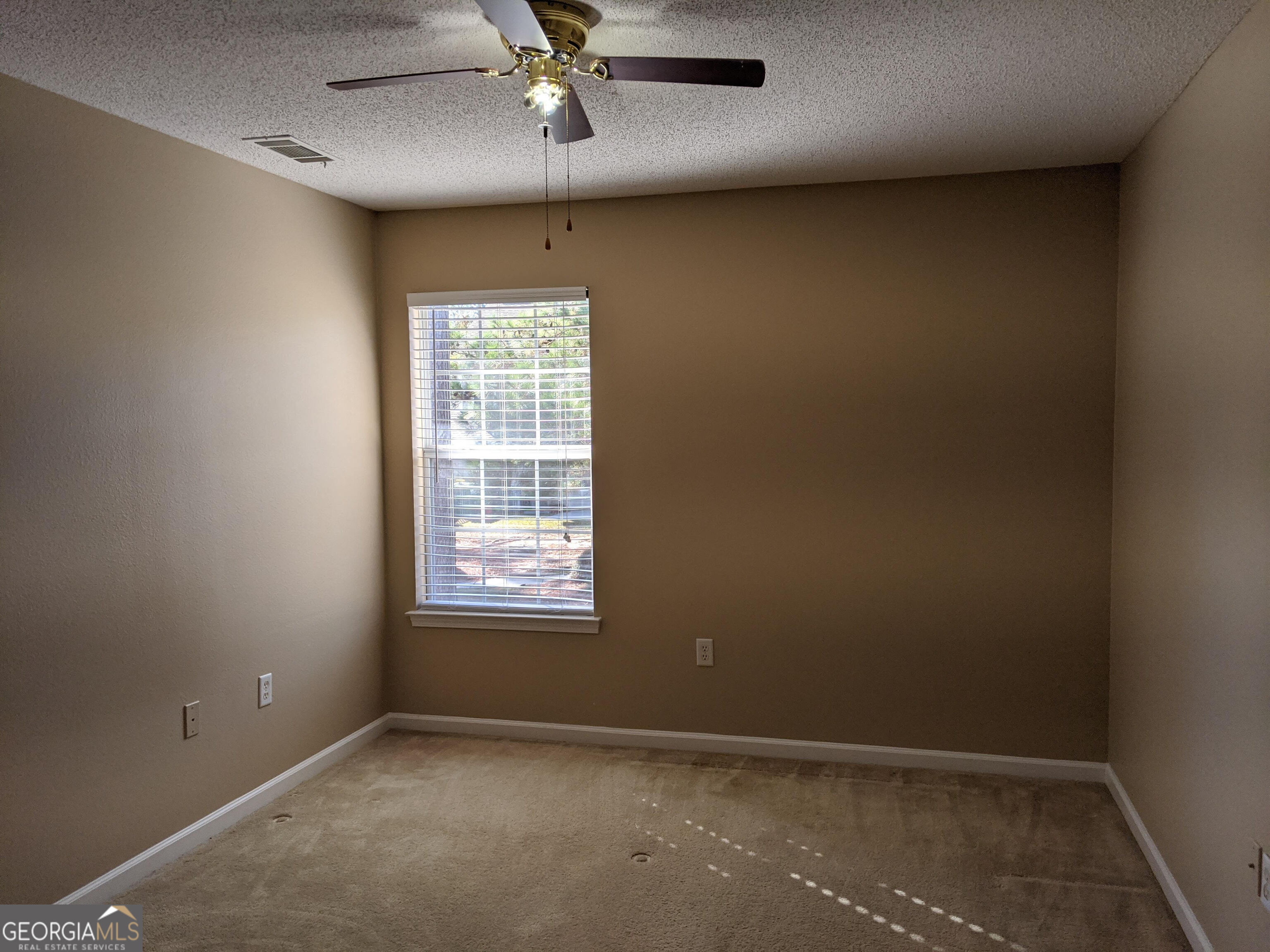 1014 Towne Park Drive East Rincon, GA 31326 - Photo 15 of 21 an empty room with a window and a fan