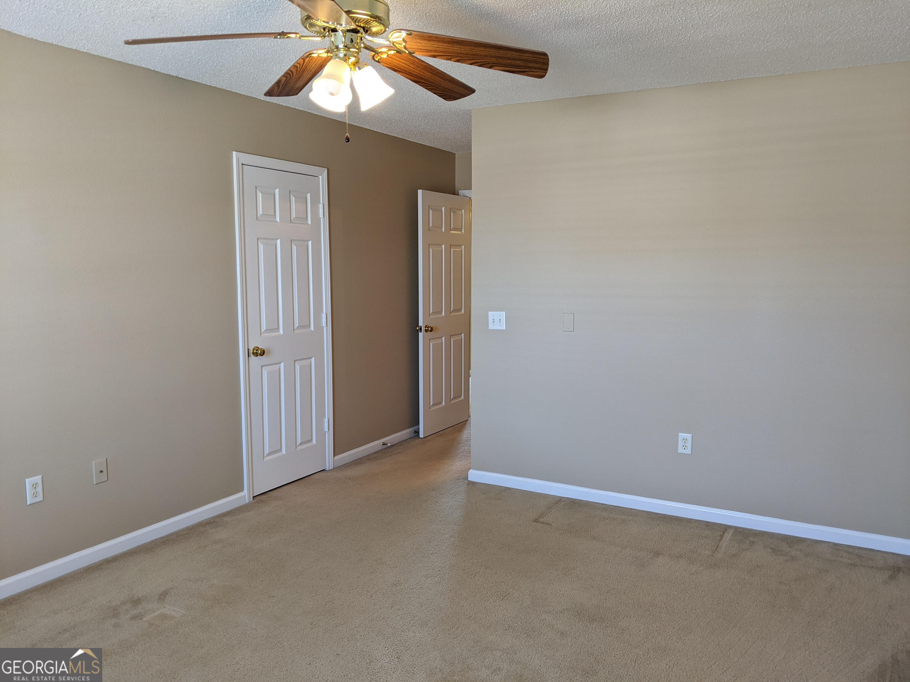 1014 Towne Park Drive East Rincon, GA 31326 - Photo 19 of 21 an empty room with a chandelier fan and windows