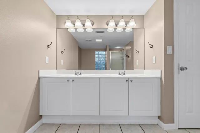 a bathroom with a toilet a sink a mirror a bathtub and vanity