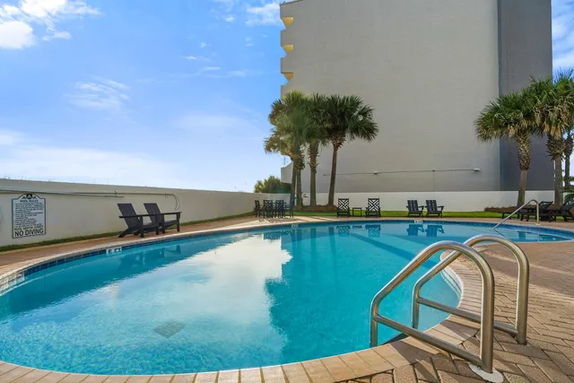 a backyard of a house with plants and outdoor seating