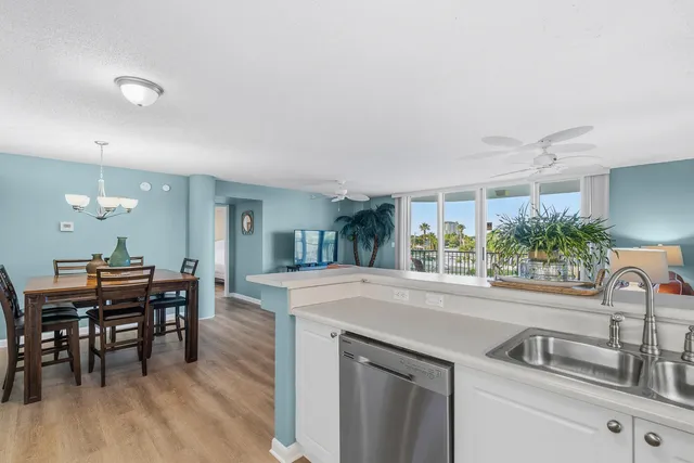 a view of a dining room with furniture wooden floor and chandelier