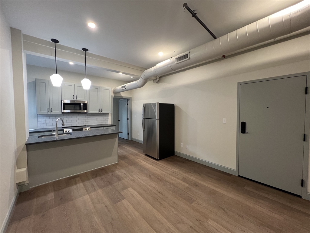 160 Seabury Street, Unit 7 Fall River, MA 02720 - Photo 1 of 11 a large kitchen with granite countertop a large counter top stainless steel appliances and cabinets