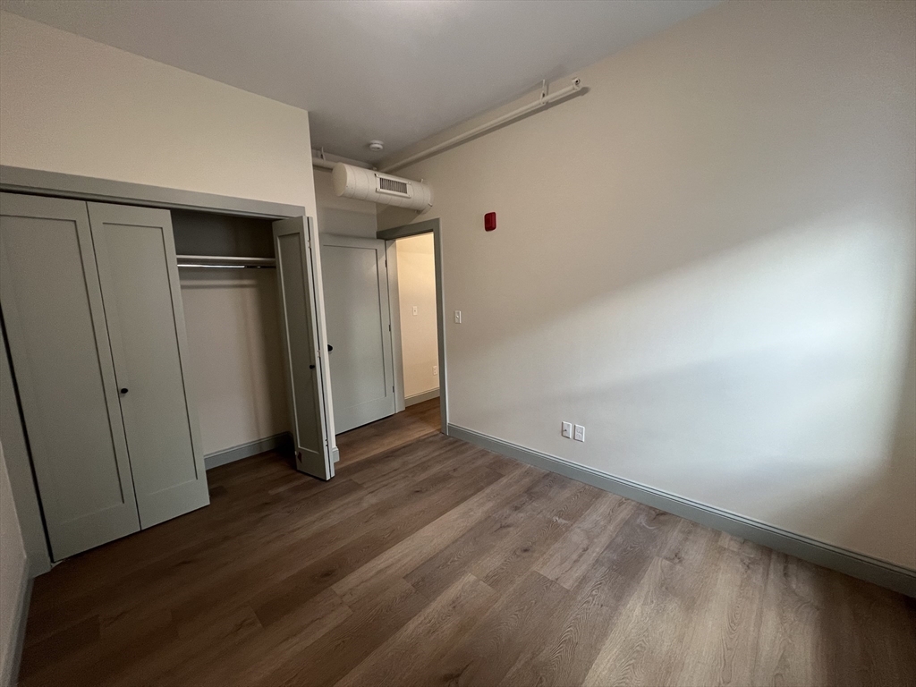 160 Seabury Street, Unit 7 Fall River, MA 02720 - Photo 6 of 11 a view of an empty room with wooden floor