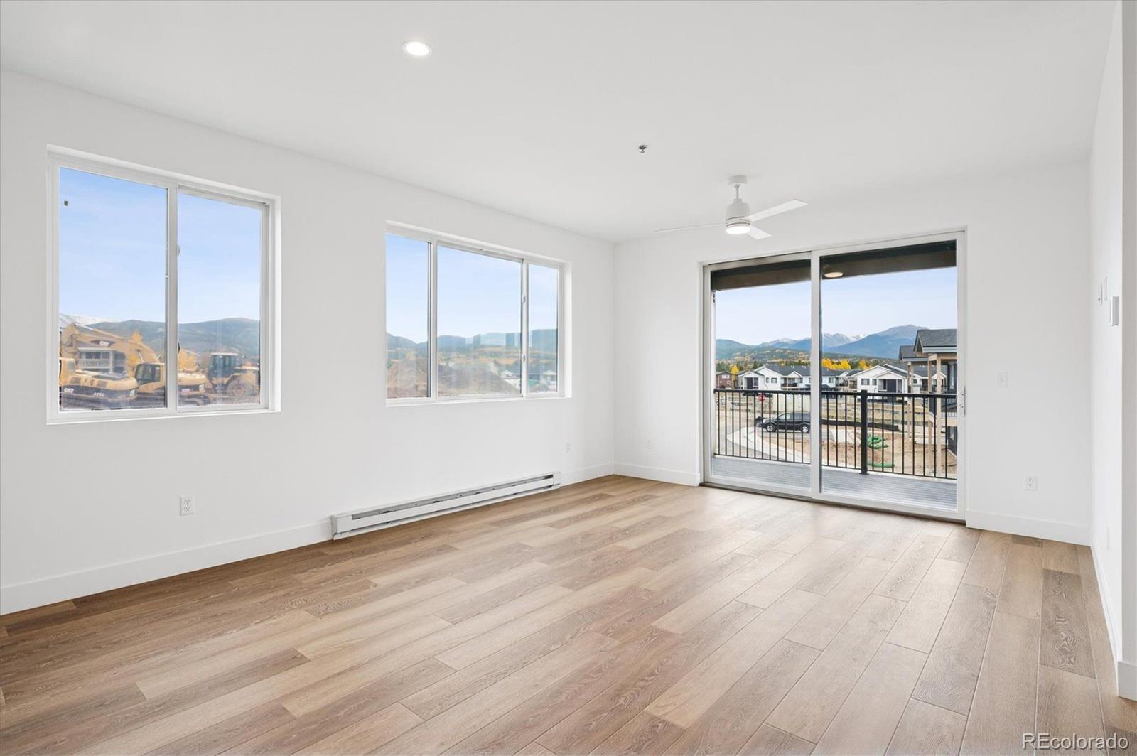 360 Sterling Way, Unit 2 Fraser, CO 80442 - Photo 13 of 30 a view of an empty room with wooden floor and a window