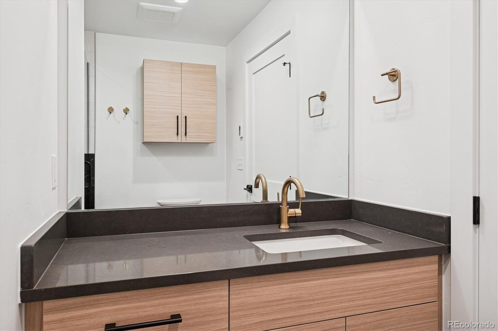 360 Sterling Way, Unit 2 Fraser, CO 80442 - Photo 19 of 30 a close view of a sink a counter and a mirror in a bathroom