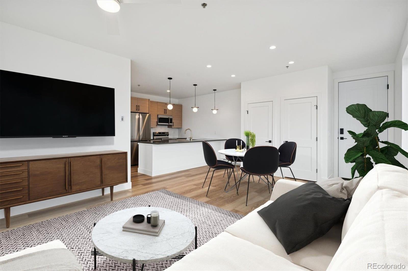360 Sterling Way, Unit 2 Fraser, CO 80442 - Photo 2 of 30 a living room with furniture and a flat screen tv