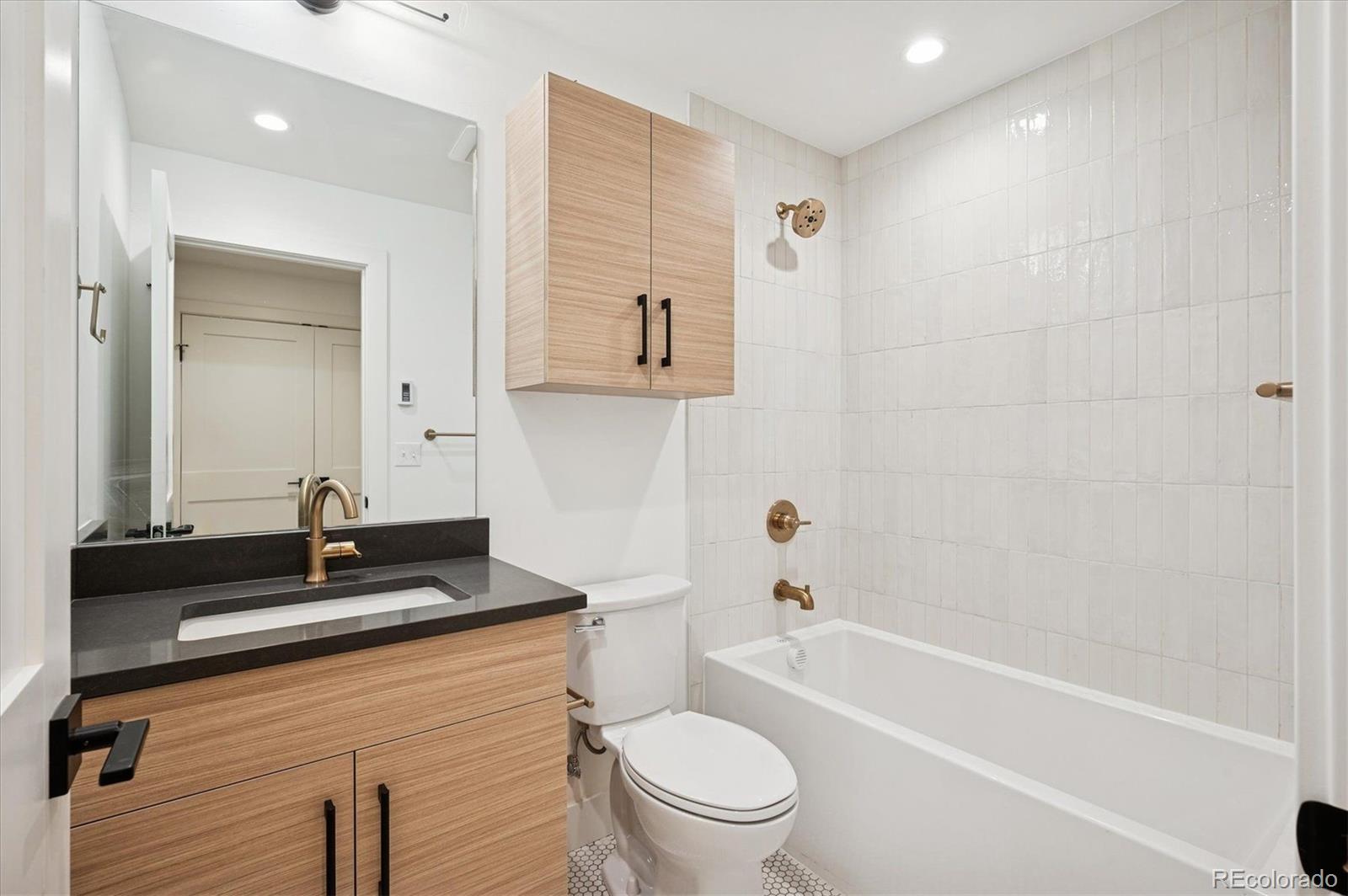 360 Sterling Way, Unit 2 Fraser, CO 80442 - Photo 22 of 30 a bathroom with a toilet a sink a mirror and bathtub