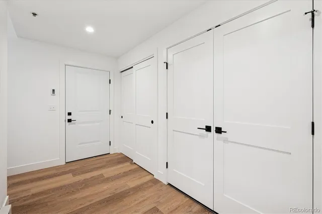 a view of a room with wooden floor