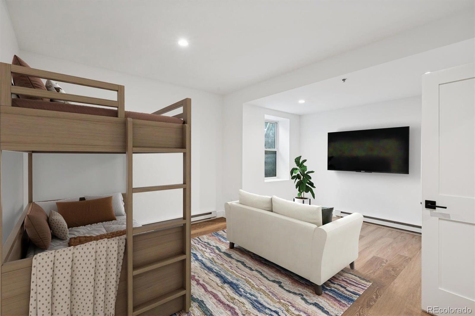 360 Sterling Way, Unit 2 Fraser, CO 80442 - Photo 3 of 30 a living room with furniture and a flat screen tv