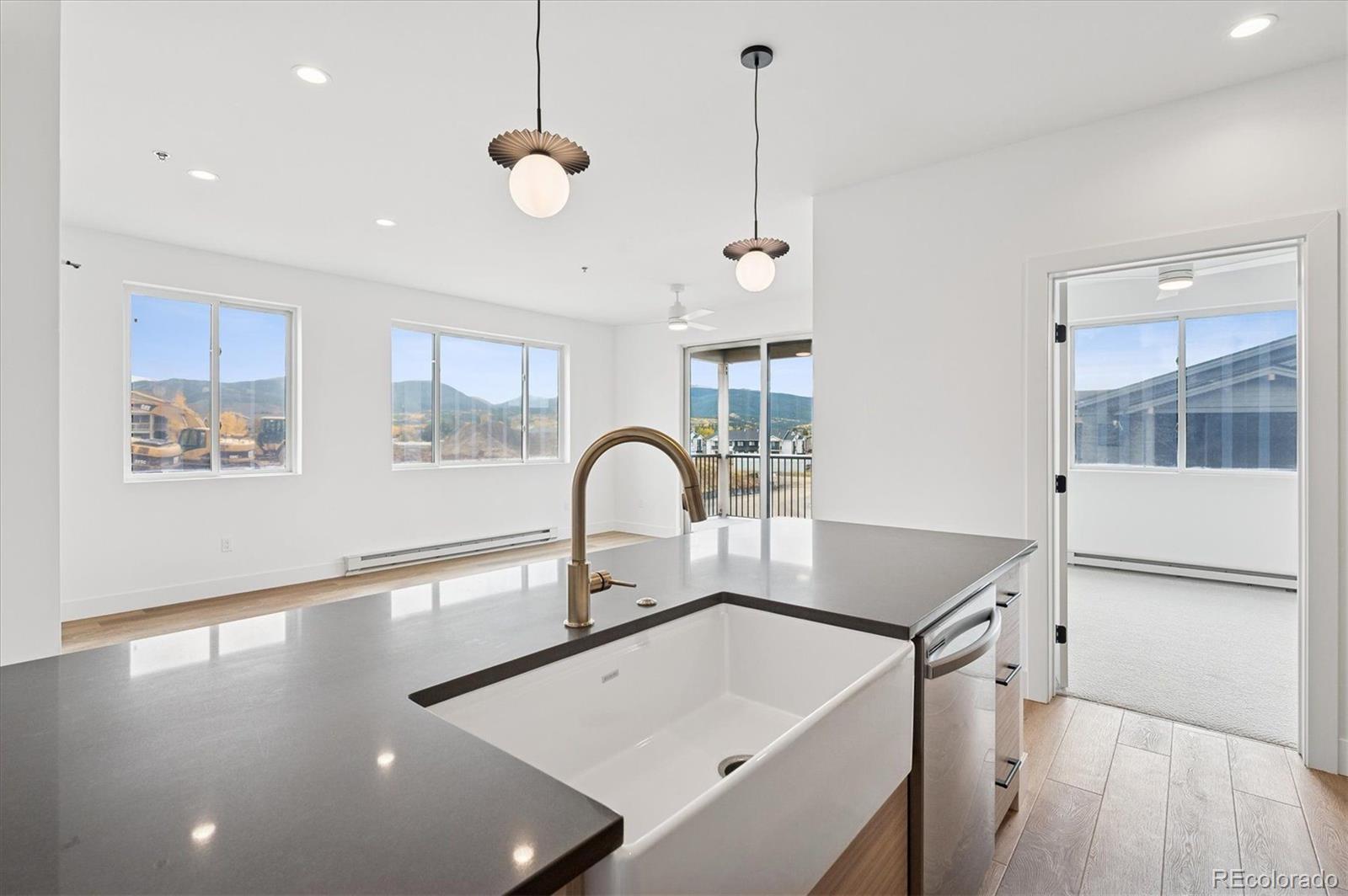 360 Sterling Way, Unit 2 Fraser, CO 80442 - Photo 9 of 30 a kitchen with a sink a counter top space and a window