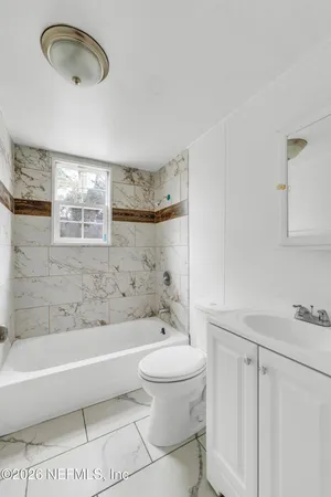 a bathroom with a toilet a sink and bathtub
