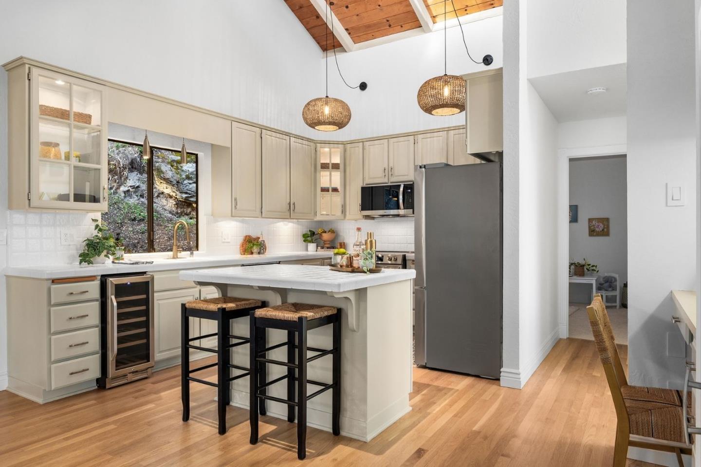 231 Nelson Road Scotts Valley, CA 95066 - Photo 13 of 54 a kitchen with a table chairs refrigerator and cabinets