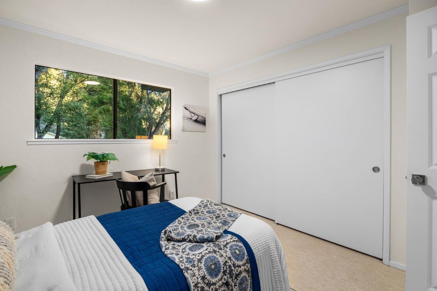 231 Nelson Road Scotts Valley, CA 95066 - Photo 39 of 54 a bedroom with a bed and a table