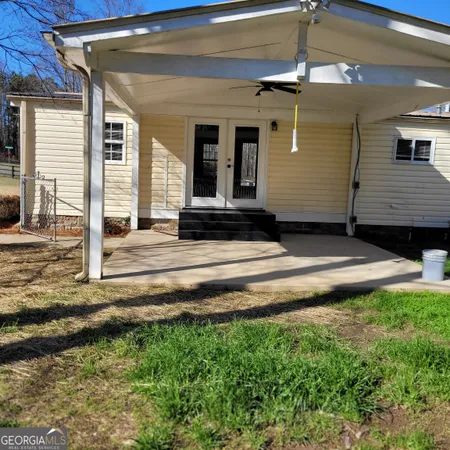 a view of a house with backyard and porch