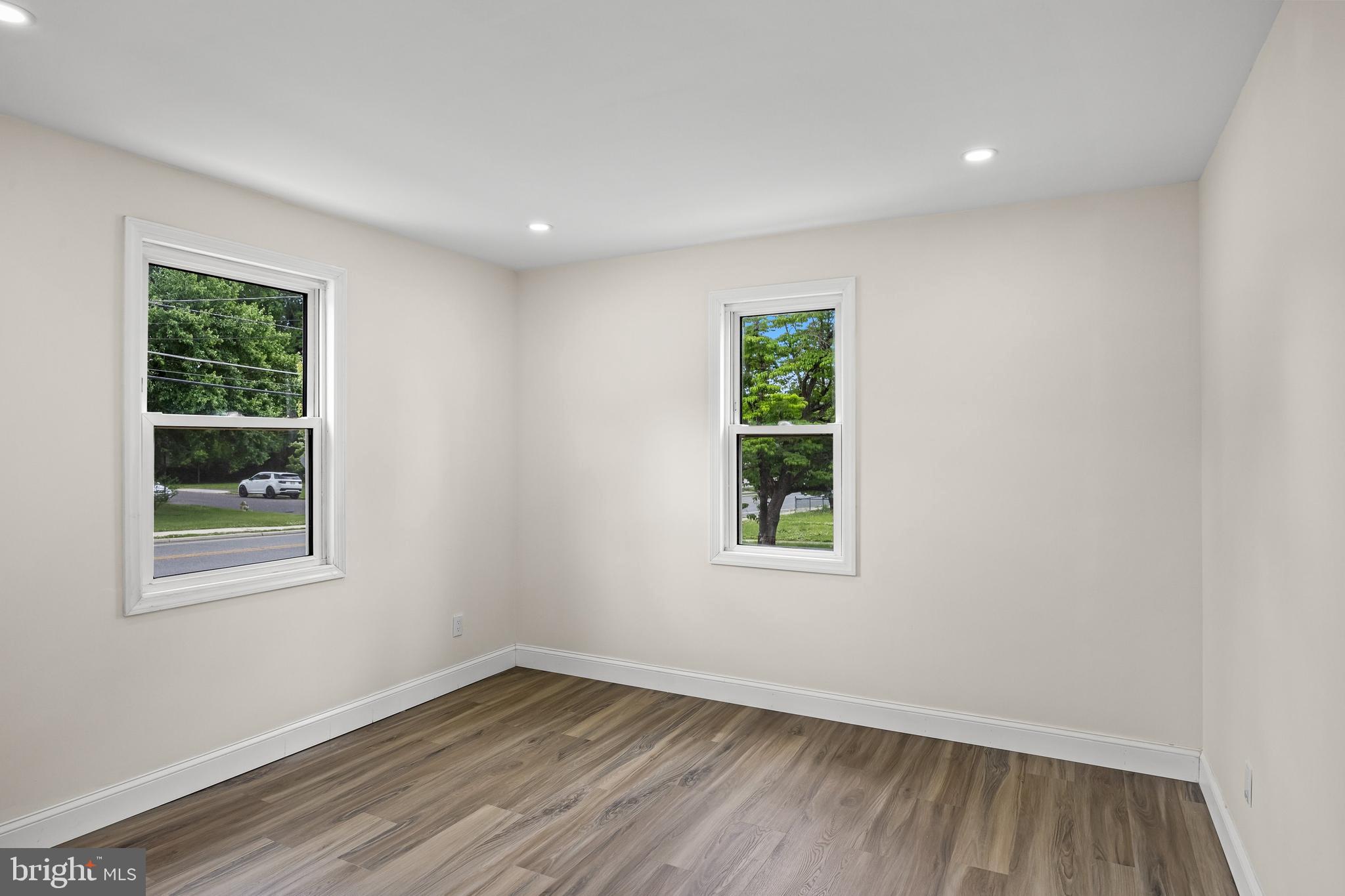 937 Clements Bridge Road Barrington, NJ 08007 - Photo 24 of 34 an empty room with wooden floor and windows